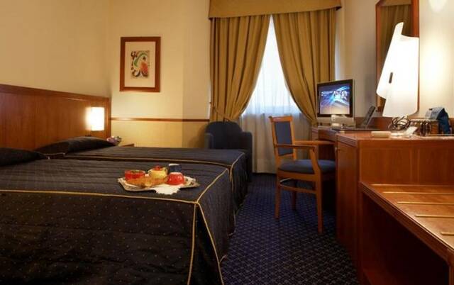 Slaapkamer met twee losse bedden in Hotel Fortino Turijn